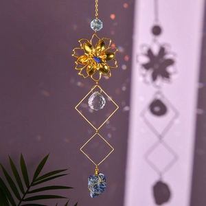 Macro detail of golden metal flower suncatcher with raw blue crystal stone and rainbow light