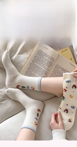 Détail de chaussettes blanches avec motifs de dessins animés et bords côtelés bleus