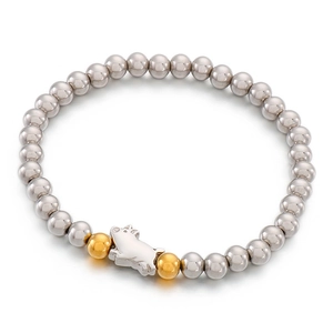 Stretch steel bead bracelet with silver pig pendant and golden accent beads on white background