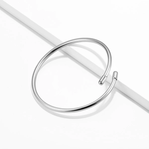 Minimalist 925 sterling silver open bangle with high-polished finish on white background
