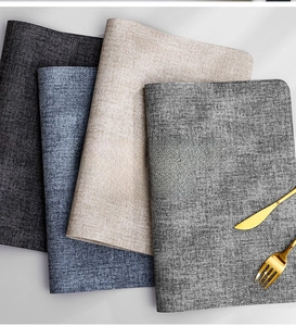Close-up of heat-resistant leather placemats with woven linen texture in four colors