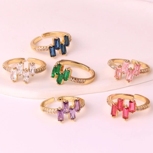 Gold-plated adjustable rings with colorful rectangular zircon stones in a top-down view