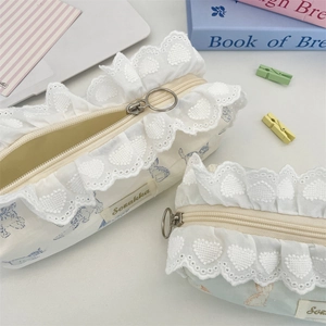 Close-up of heart-shaped lace detail and round zipper on cute cat print pencil case