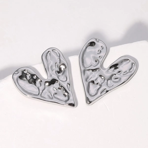 Irregular silver heart stud earrings with minimalist lava texture in stainless steel