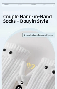 Close-up of white ribbed knit magnetic hand-holding socks with 3D eyes decoration