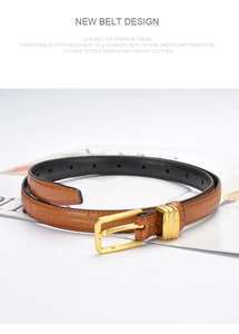 Detail of a brown croc-effect leather belt with a matte gold square pin buckle