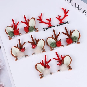Detailed view of assorted Christmas reindeer antler hair clips with bells and fur balls