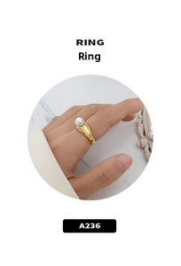 Detailed view of polished 18k gold plated ring featuring a round freshwater pearl accent