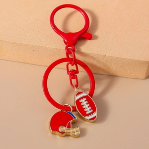 Close-up of red American football and helmet charms on a durable metal keychain