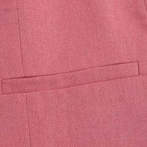 Close-up of pink woven fabric texture and premium welt pocket stitching detail
