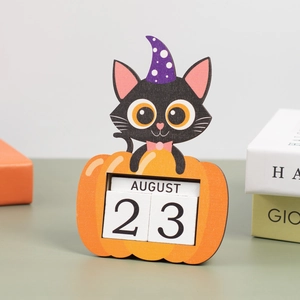 Close-up of wooden Halloween countdown calendar featuring a black cat and pumpkin design