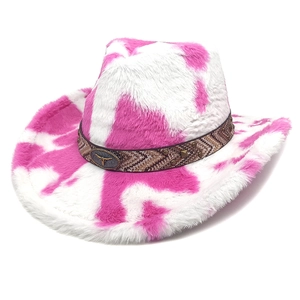 Close-up of pink cow print plush cowboy hat with metal bull head badge and patterned strap