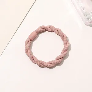 Detail of pink three-strand braided elastic hair tie with matching cylindrical bead