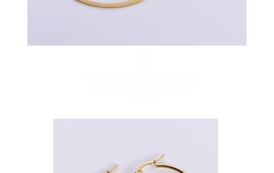 Close-up of gold-plated titanium steel hoop earrings with snap closure mechanism