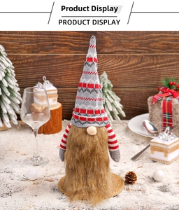 Detail of Christmas gnome wine bottle cover with knitted hat and fuzzy beard decoration