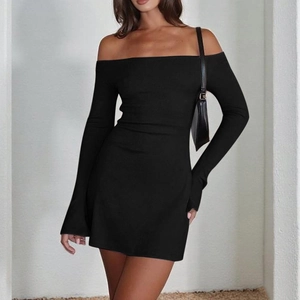 Close-up of elegant off-shoulder long sleeve black mini dress with knit texture detail