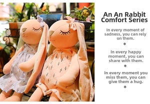 Detail of soft plush rabbit dolls wearing floral dresses in a garden setting