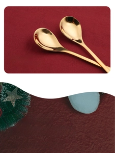 Close-up of polished golden stainless steel dessert spoons with glossy metallic finish