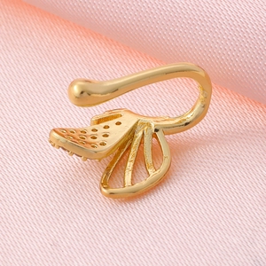 Detail of a gold lotus-shaped clip-on nose ring with micro-set zircon on pink silk