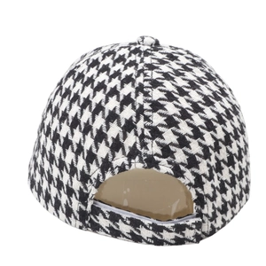 Detail view of adjustable back strap and houndstooth woven fabric on baseball cap