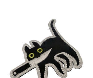 Detailed embroidery of a cute black cat holding a knife meme patch on white background