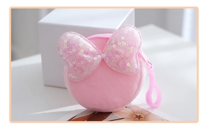 Close-up of pink plush coin purse with glittery bow and secure plastic snap hook