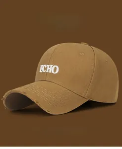 Detail of distressed brim and ECHO embroidery on khaki cotton baseball cap