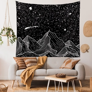 Minimalist mountain and starry night sky wall tapestry hanging in a modern living room