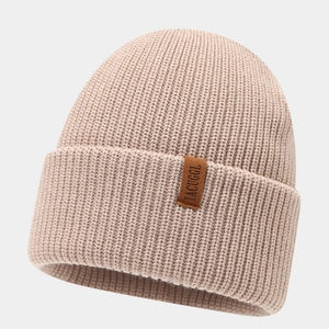 Close-up of knit texture and premium leather patch on oatmeal winter beanie hat