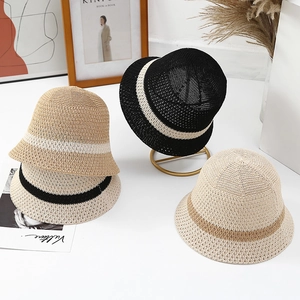 Detailed view of several stylish knitted bucket hats in neutral tones for summer sun