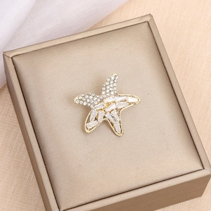 Elegant gold starfish brooch with sparkling cubic zirconia in a premium gift box