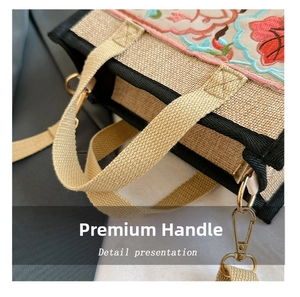 Close-up of ethnic floral embroidery and braided shoulder strap on the canvas tote bag