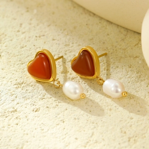 Elegant gold heart earrings with red agate stones and white teardrop pearl pendants