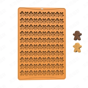 Detail of orange silicone baking mold with 77 mini gingerbread man cavities and snacks