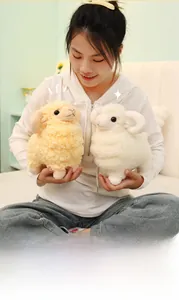 Close-up of soft plush lamb toy set held by model, showing fluffy texture and round shape