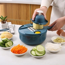 Action shot of a multifunctional vegetable slicer being used to slice potatoes in a kitchen