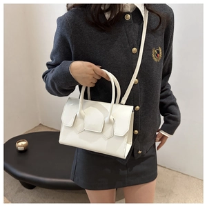 White minimalist leather handbag shown on model for professional daily office outfit style