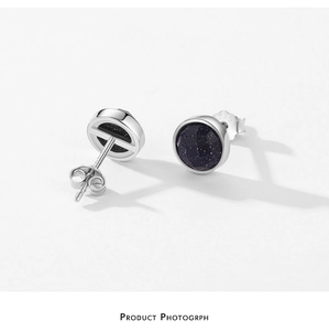 Detailed view of S925 sterling silver stud earrings with sparkling round blue stones