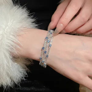 Three-layer silver bangle featuring sparkling zircon and deep blue square gemstones