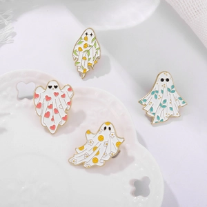 Cute faceless ghost enamel pin set with tulip and heart patterns on a white ceramic plate