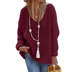 Detail of burgundy V-neck knitted sweater featuring thick chunky knit texture and loose fit
