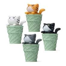 Detailed view of four miniature cats in green waffle cone cups for fairy garden decor