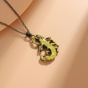 Macro detail of antique bronze scorpion pendant necklace with detailed metal texture