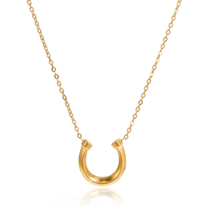Close-up of polished gold horseshoe pendant necklace with a fine cross chain on white