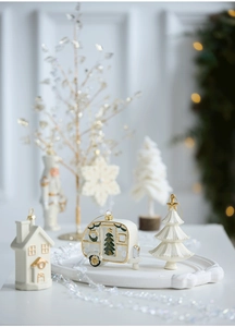 Detailed view of cream white and gold Christmas hanging ornaments in various shapes