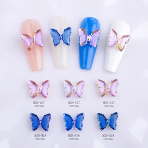 3D butterfly nail art charms with iridescent purple crystals and metallic borders