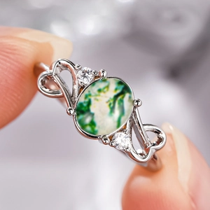 Elegant moss agate ring with silver heart cutout band and sparkling side zirconias