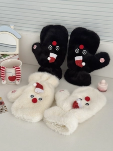 Detail of plush snowman mittens with red hats and checkered buttons on a white surface
