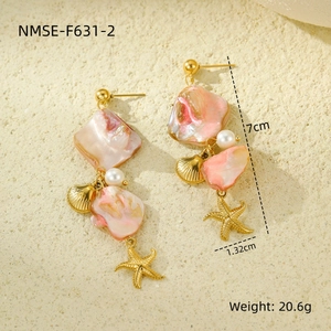 Detail view of gold ocean shell earrings showing dimensions 7cm x 1.32cm and 20.6g weight