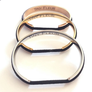 Three minimalist stainless steel C-shaped cuff hair ties in rose gold, gold, and silver colors